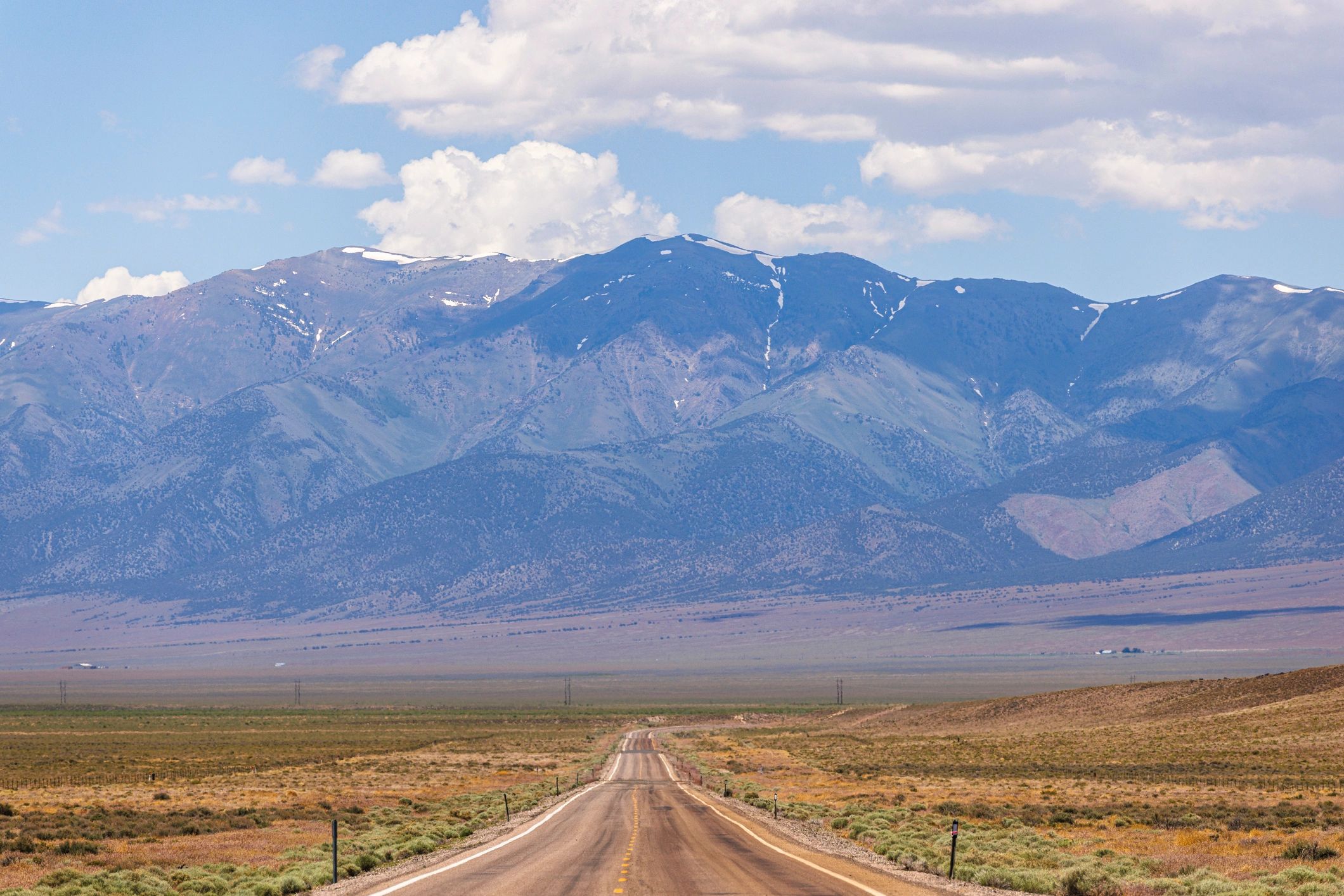 Nevada highway leading through desert communities and mountain landscape